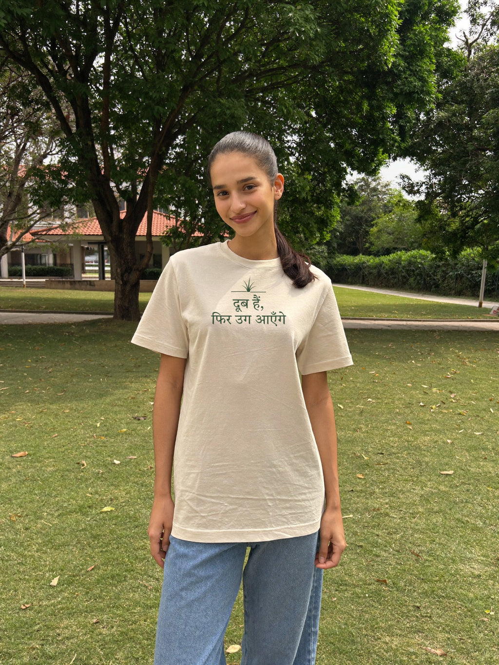 Woman wearing the “दूब हैं, फिर उग आएँगे” t-shirt by Halant, campus garden