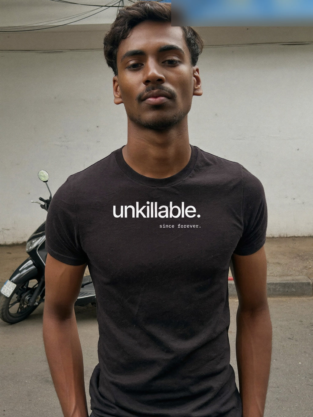 Man wearing the “unkillable. since forever.” minimal typography t-shirt in black by Halant, bangalore lane